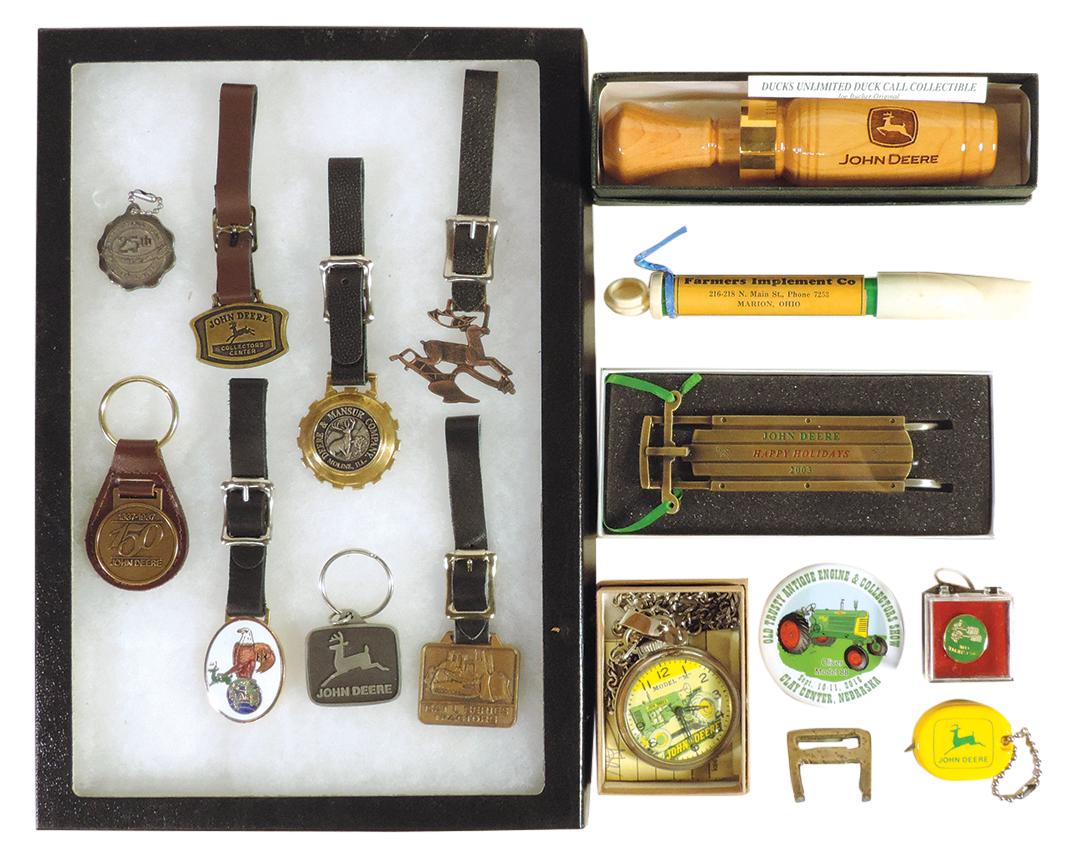 John Deere Memorabilia (14), collection of 7 diff contemporary fobs, enameled case fob, 2003 sled: John Deere Memorabilia (14), collection of 7 diff contemporary fobs, enameled case fob, 2003 sled ornament, Joe Bucher DU game call & other items-incl fantasy model M pocket watch (working), most Exc 
