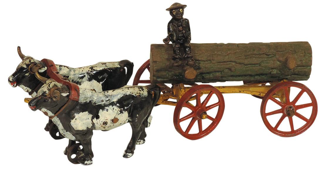 Black Americana Toy, oxen pulling log wagon w/black driver, cast iron, mfgd by Hubley or Kenton, VG+: Black Americana Toy, oxen pulling log wagon w/black driver, cast iron, mfgd by Hubley or Kenton, VG+ orig cond & paint, 15.5"L.