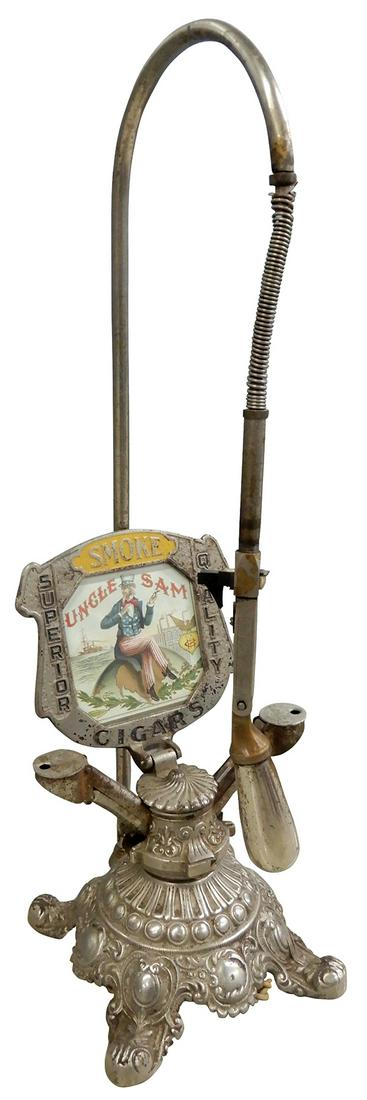 Cigar Cutter & Electric/Gas Lighter, cast iron base marked Brunhoff Mfg. Co.-Cinc, O., double cutter: Cigar Cutter & Electric/Gas Lighter, cast iron base marked Brunhoff Mfg. Co.-Cinc, O., double cutters marked Pat. 1902 & gas lighter mfgd by Eldred Mfg.-Chicago, has advertising marquee for Uncle Sam 
