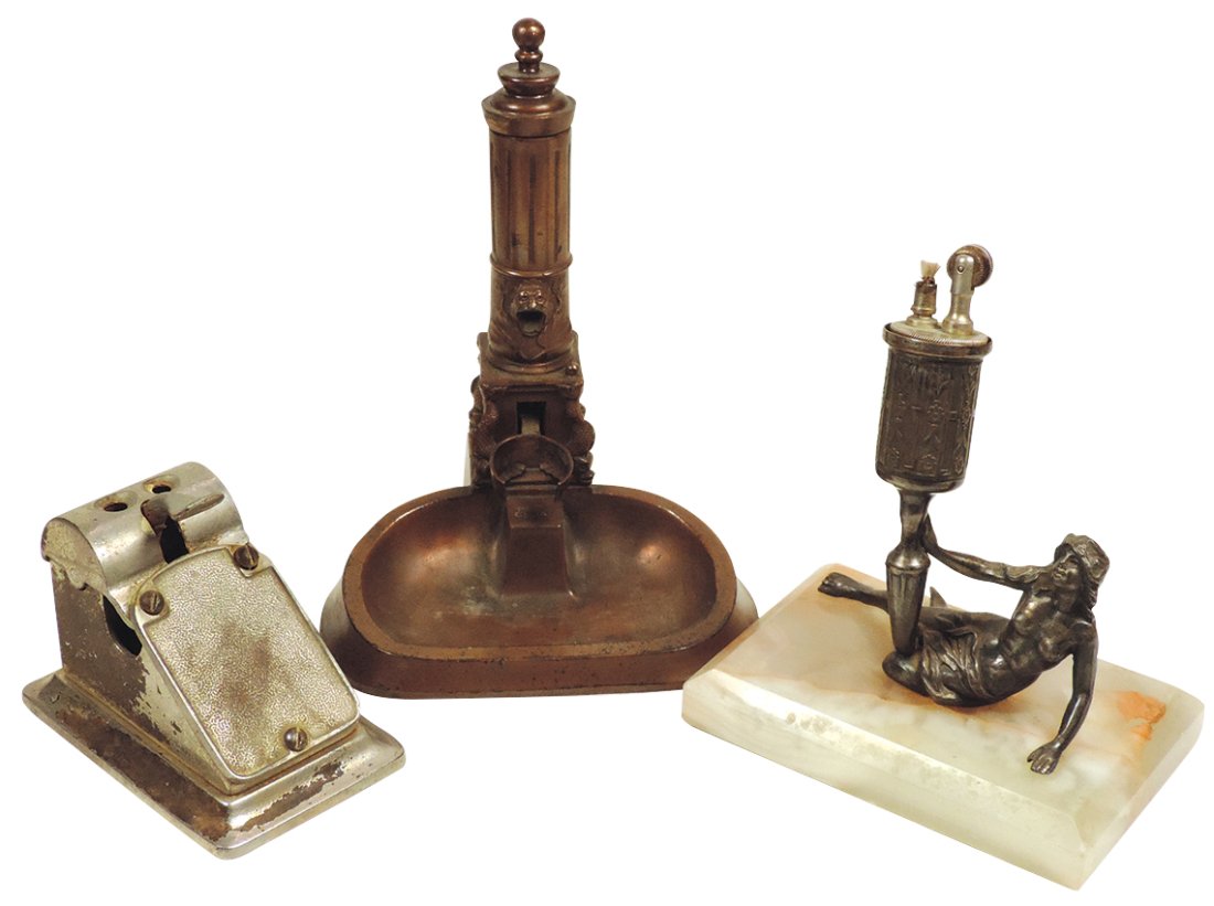 Cigar Lighter & Cutters (3), brass cistern pump, fueled wick holder (missing) lifts to mouth of: Cigar Lighter & Cutters (3), brass cistern pump, fueled wick holder (missing) lifts to mouth of pump, handle goes down & spark lights wick, marked 1911 on back, probably German,a semi-nude reclining m