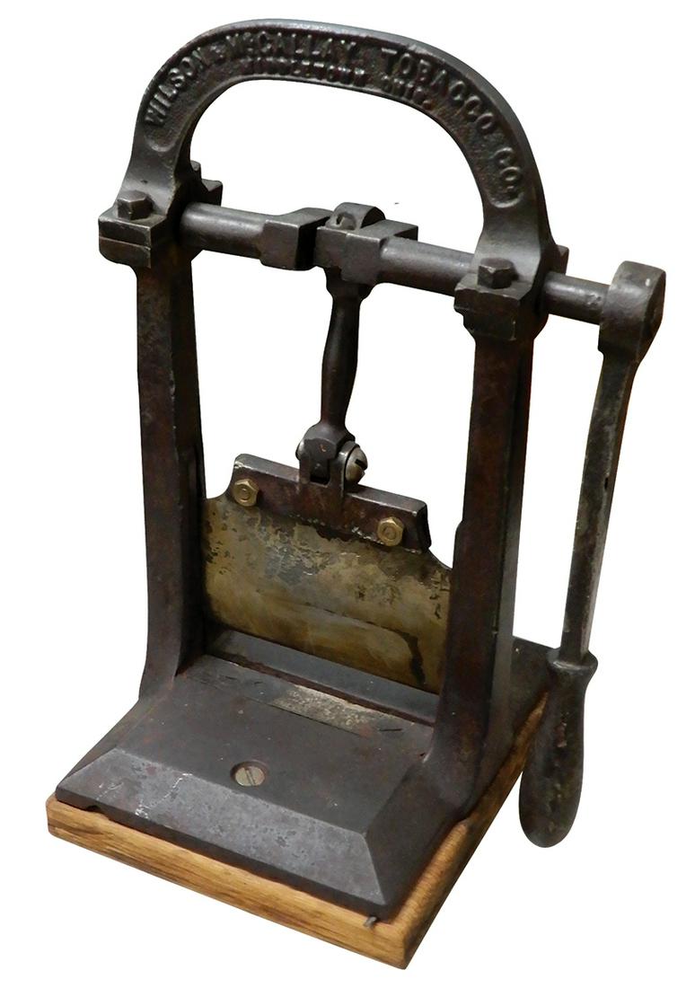 Tobacco/Cigar Cutter, Guillotine type, mfgd by Wilson & McCallay Tobacco Co.-Middletown, OH, cast: Tobacco/Cigar Cutter, Guillotine type, mfgd by Wilson & McCallay Tobacco Co.-Middletown, OH, cast iron w/wood base, c.1910, VG orig cond, 13"H x 6.5"W x 7.5"D.