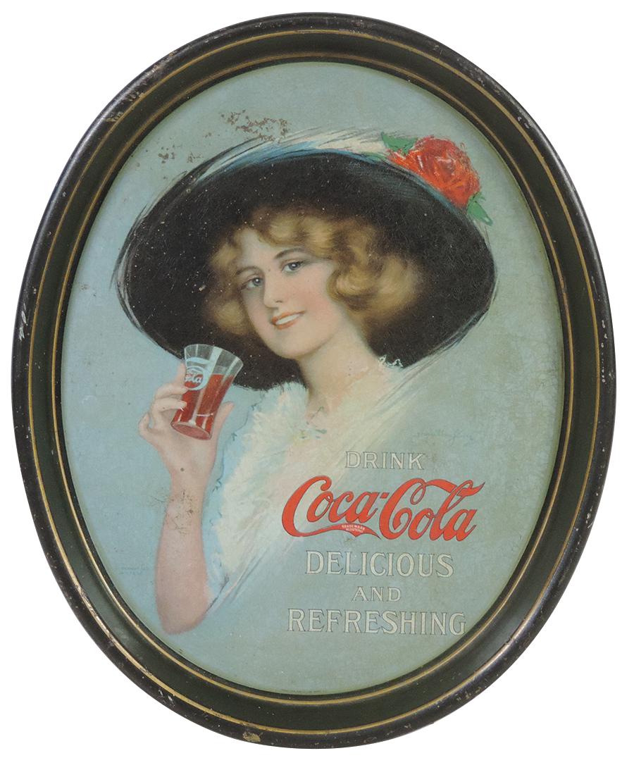 Coca-Cola Serving Tray, 1913 Girl in Black Hat w/Rose by artist Hamilton King, oval lithographed tin: Coca-Cola Serving Tray, 1913 Girl in Black Hat w/Rose by artist Hamilton King, oval lithographed tin by Passaic Metal Ware Good cond w/checking & oxidized spotting 15"H x 12.5"W.
