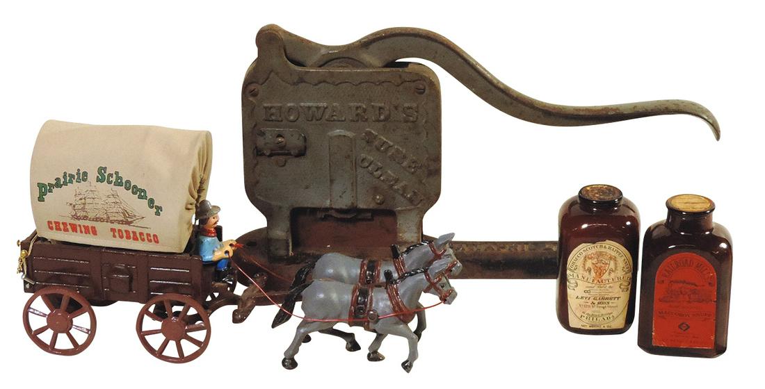 Tobacciana (4), Howard's cast iron tobacco cutter, 2 brown glass snuff jars w/paper labels: Levi: Tobacciana (4), Howard's cast iron tobacco cutter, 2 brown glass snuff jars w/paper labels: Levi Garrett & Sons & Railroad Mills, both w/contents & cast iron Prairie Schooner Chewing Tobacco toy wagon