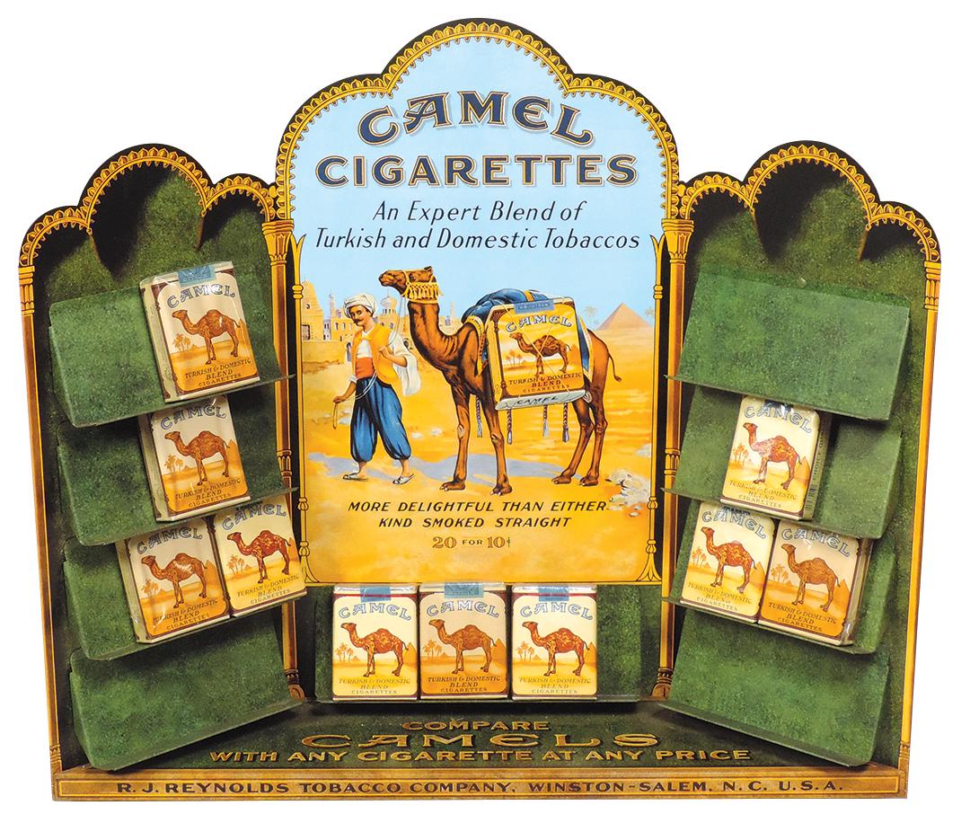 Tobacciana, Camel Cigarettes, diecut litho on tin retro counter display for 20 packs of 20, incl 10: Tobacciana, Camel Cigarettes, diecut litho on tin retro counter display for 20 packs of 20, incl 10 old & new packages, Exc cond, 18"H x 20.5"W.