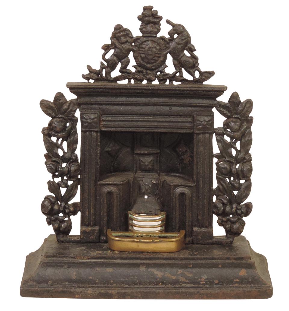 Salesman's Sample or Child's Stove, English cast iron model of fireplace w/brass inserts,: Salesman's Sample or Child's Stove, English cast iron model of fireplace w/brass inserts, reticulated florals & armorial crest, VG cond w/some oxidation, 14.5"H.