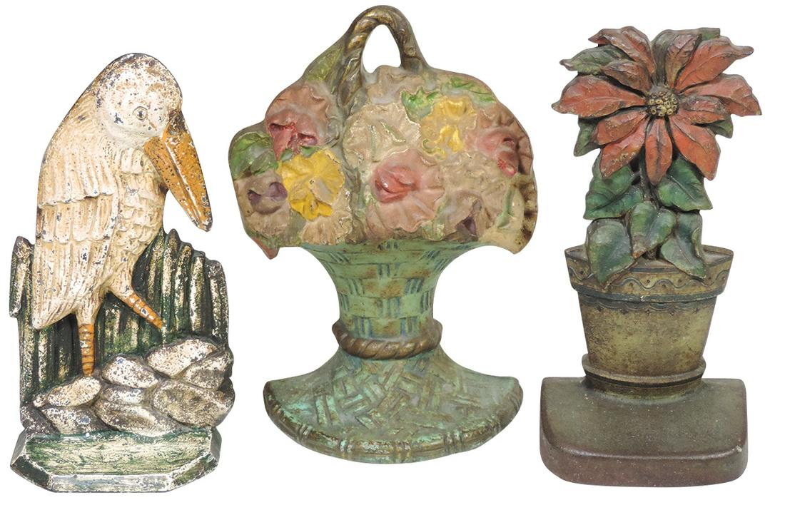 Doorstops (3), Flower Basket by Waverly Studios-Wilmette, IL, dtd 1925, Poinsettia by Judd Co. &: Doorstops (3), Flower Basket by Waverly Studios-Wilmette, IL, dtd 1925, Poinsettia by Judd Co. & Pelican in Rushes, all cast iron w/orig paint, VG or VG+ cond, largest 10"H.