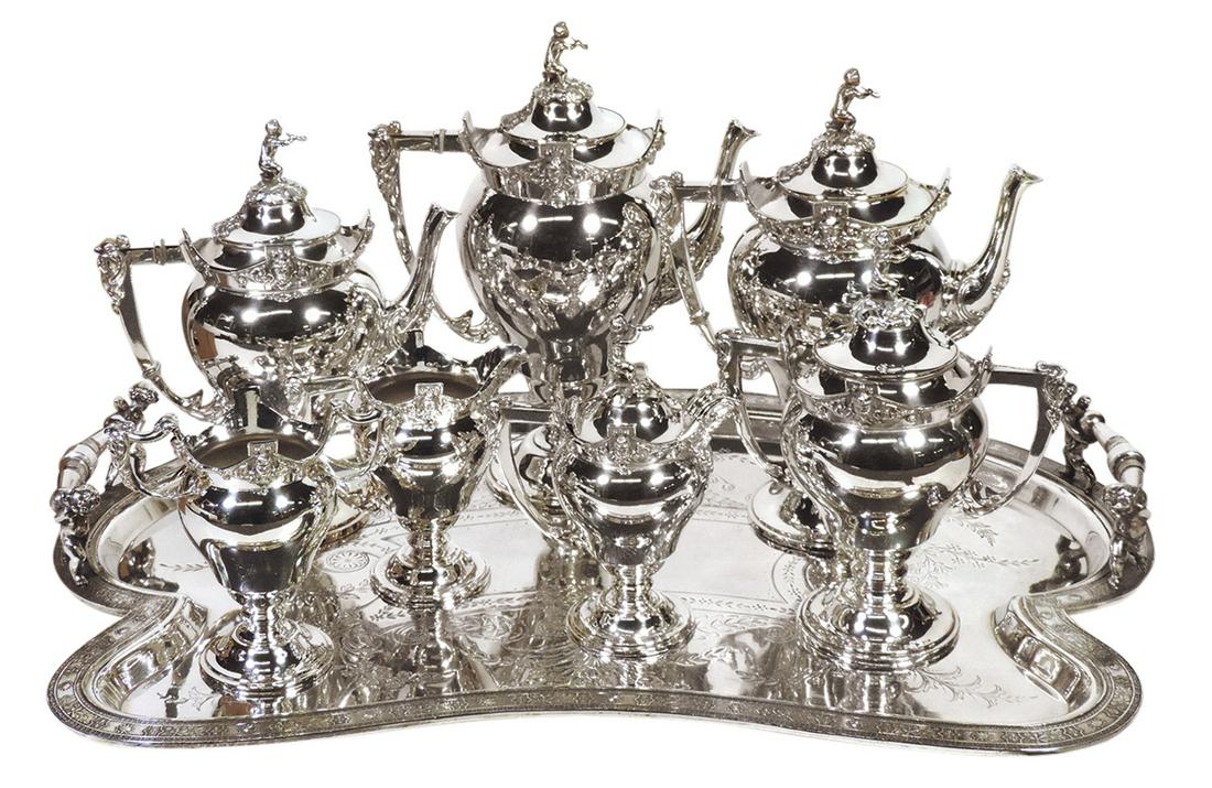 Victorian Silvered Coffee & Tea Service (8), New Haven 1878 quadruple plate w/embossed facial masks: Victorian Silvered Coffee & Tea Service (8), New Haven 1878 quadruple plate w/embossed facial masks & figural putti blowing horns finials, coffee, tea & hot chocolate pots, covered cream & sugar & ope