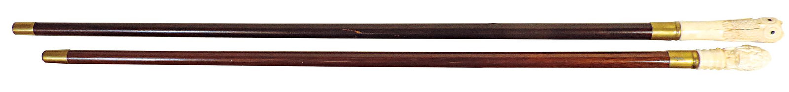 Walking Sticks (2), owl w/jeweled eyes & erotic bust of nude figures, carved tusk handles, each on: Walking Sticks (2), owl w/jeweled eyes & erotic bust of nude figures, carved tusk handles, each on mahogany shafts, VG cond, noting shrinkage cracks in handles, largest 37.5"L.