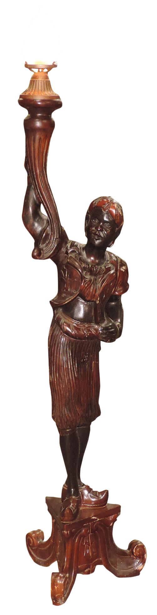 Lighting, Blackamoor floor lamp, carved 2-toned figure on tripod plinth holding a lamp w/molded: Lighting, Blackamoor floor lamp, carved 2-toned figure on tripod plinth holding a lamp w/molded glass flame form shade, VG working cond w/some wear/abrasions, 64"H.