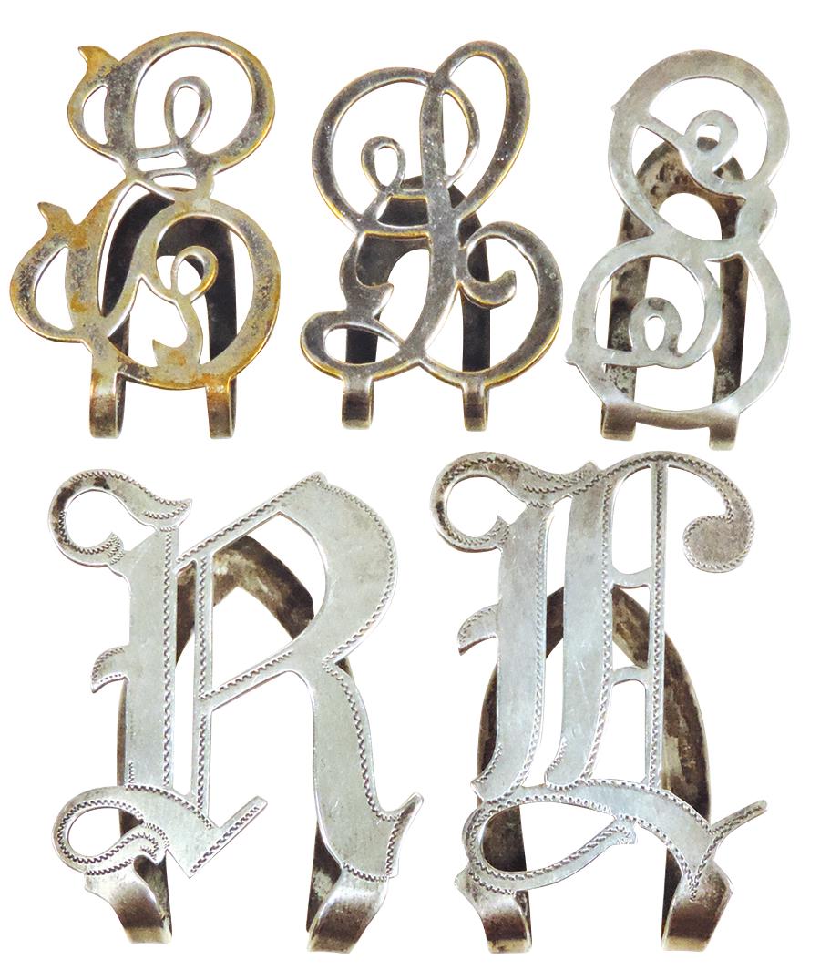 Sterling Silver Napkin Clips, initials "R", "H", "L" & "G", "E" & "L", "L" & "E" marked Apollo: Sterling Silver Napkin Clips, initials "R", "H", "L" & "G", "E" & "L", "L" & "E" marked Apollo Silver, others marked Sterling, Exc cond, 1 5/8" to 2 1/16"H.