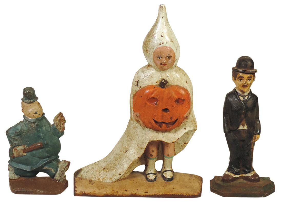 Doorstops (3), Halloween girl w/jack-o'lantern, Charlie Chaplin & Cop, all later vintage cast iron: Doorstops (3), Halloween girl w/jack-o'lantern, Charlie Chaplin & Cop, all later vintage cast iron in VG cond, largest 13.5"H.