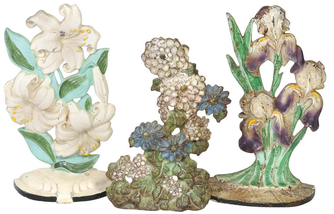 Doorstops (3), Hubley Iris, B&H Mixed Flowers & LVL Candlestick Crafts Zinnias Wedge, cast iron in: Doorstops (3), Hubley Iris, B&H Mixed Flowers & LVL Candlestick Crafts Zinnias Wedge, cast iron in VG to Exc+ cond, largest 10.75"H.