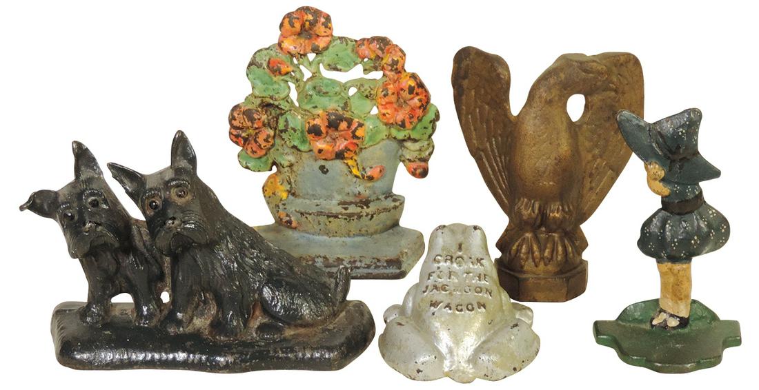Doorstops, (5), Advertising Frog embossed "I Croak For The Jackson Wagon", pair of Scotties: Doorstops, (5), Advertising Frog embossed "I Croak For The Jackson Wagon", pair of Scotties, Sunbonnet Girl, Flower Basket & Eagle, all cast iron in Good+ to VG+ cond, largest 7"H.