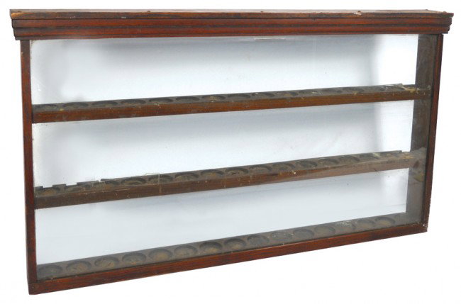 Drug store wall display cabinet, oak w/glass fron: Drug store wall display cabinet, oak w/glass front, shelves w/round recesses to hold 48 bottles, Good cond, 22"H x 40.5"W.