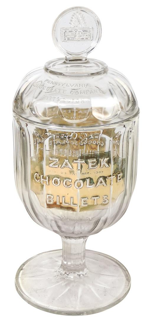 Candy Store Chocolate Dispenser, Zatek Chocolate Billets, embossed molded glass, dated 1907 on gilt: Candy Store Chocolate Dispenser, Zatek Chocolate Billets, embossed molded glass, dated 1907 on gilt ground for the Pennsylvania Chocolate Company, Exc cond, 17"H.