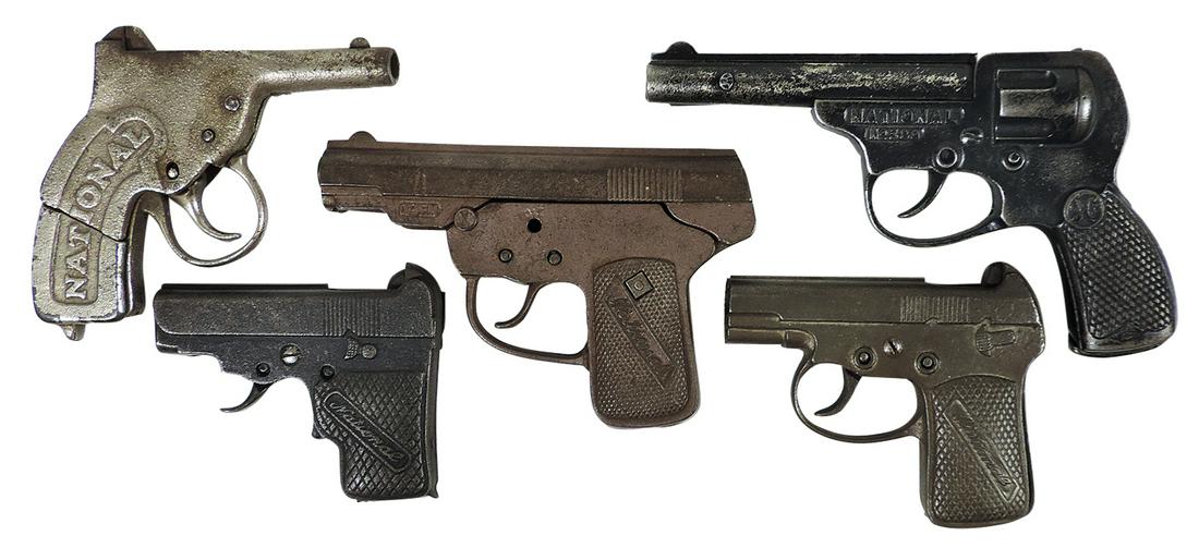 Toy Cap Guns (5), cast iron, mfgd by National, all different roll shooters, c.1920s-30s. Good+ to: Toy Cap Guns (5), cast iron, mfgd by National, all different roll shooters, c.1920s-30s. Good+ to VG working cond, largest 8"L.