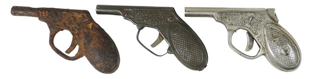 Toy Pistols (3), cast iron National Liquid Pistol, mfgd by Parker-Sterns 1900, pressed tin Jungle: Toy Pistols (3), cast iron National Liquid Pistol, mfgd by Parker-Sterns 1900, pressed tin Jungle Liquid Pistol & cast iron water pistol relic, Exc cond unless noted, largest 5.25"L.