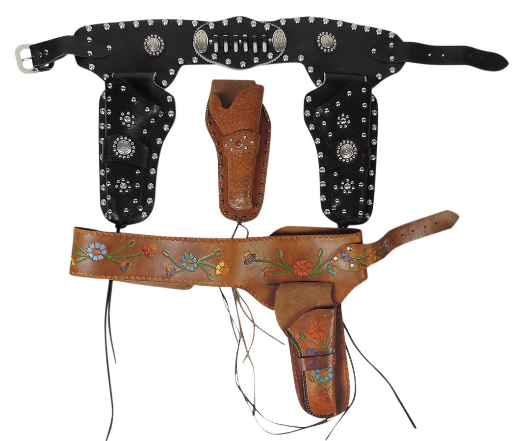 Toy Cap Gun Holsters (3), custom black leather double holster belt w/carved conchos & studs,: Toy Cap Gun Holsters (3), custom black leather double holster belt w/carved conchos & studs, tooled leather belt & single holster w/polychrome flowers & tooled leather basketweave holster w/jewel & st
