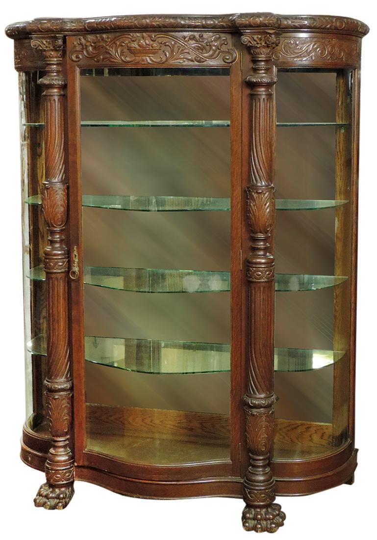 Furniture, attributed to Horner Bros., oak triple-curved china cabinet, top carved w/fruit basket, (1 of 1)