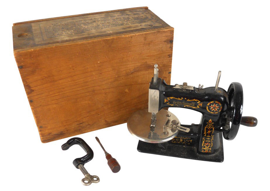 Child's Stitchwell sewing machine in orig wood box w/pa: Child's Stitchwell sewing machine in orig wood box w/paper label & instruction tag, colorful graphics, appears to be in working order w/clamp & screwdriver, Exc cond, 7"H x 9.5"W x 4.5"D.