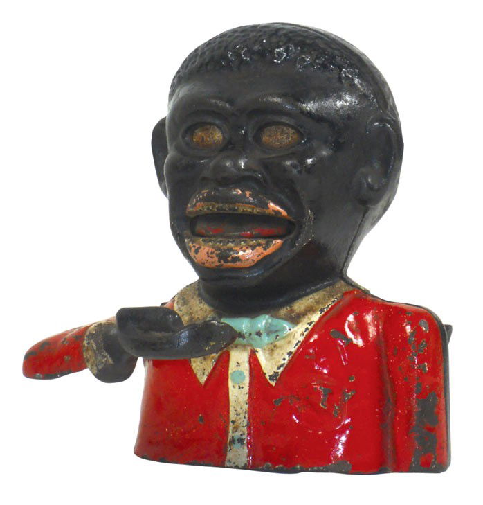 Mechanical bank, Jolly Nigger, mfgd by Sydenham & McOus: Mechanical bank, Jolly Nigger, mfgd by Sydenham & McOustra-England, c.1935, painted cast iron, missing bottom plate, o/wise VG cond w/orig paint, 5"H x 4.75"W.