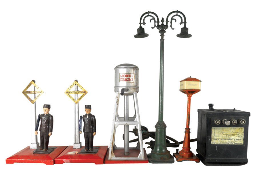 Toy train accessories (6), Lionel Lines water tower, st: Toy train accessories (6), Lionel Lines water tower, street light, (2) #1045 flagmen (1 flagman's hand w/flag is broken but piece is included; other flagman is missing flag), #57 lighted street sign &