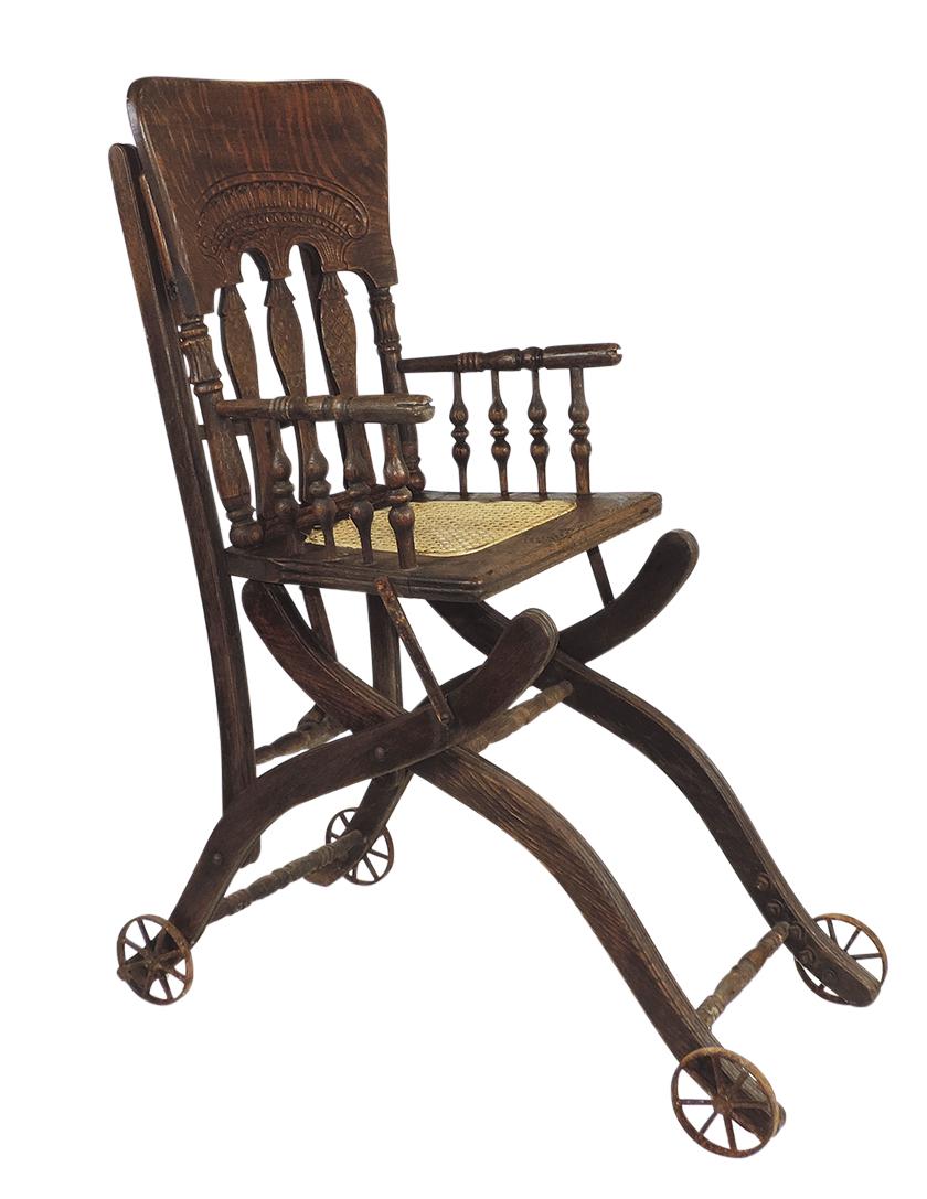 Child's convertible highchair/stroller, Victorian oak w/pressed back, woven seat & iron wheels,: Child's convertible highchair/stroller, Victorian oak w/pressed back, woven seat & iron wheels, Good+ cond, 40.5"H.