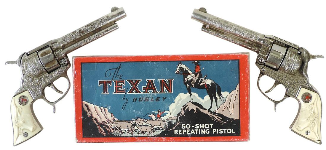 Toy Cap Guns & Box (3), 2 Texan six shooters, mfgd by Hubley, 1 cast iron, 1 die-cast (grip chip): Toy Cap Guns & Box (3), 2 Texan six shooters, mfgd by Hubley, 1 cast iron, 1 die-cast (grip chip) plus orig box, VG+ cond, largest 9.5"L.