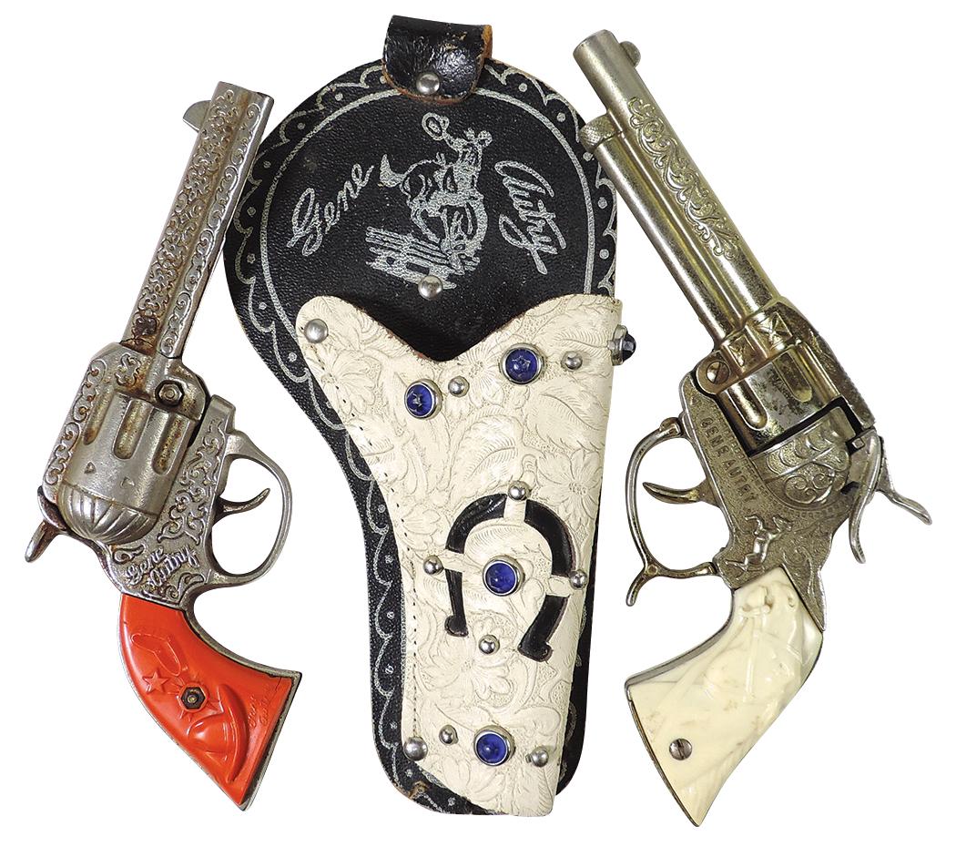 Toy Cap Pistols (2), both Gene Autry, 1 by Kenton w/red grips, cast iron & 1 in jeweled holster by: Toy Cap Pistols (2), both Gene Autry, 1 by Kenton w/red grips, cast iron & 1 in jeweled holster by M.A. Henry, die-cast, VG working cond, larger 10"L.