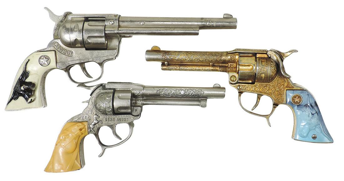 Toy Cap Pistols (3), mfgd by Hubley, gold tone Texan, Cowboy & Gene Autry, die-cast, Good+ to VG: Toy Cap Pistols (3), mfgd by Hubley, gold tone Texan, Cowboy & Gene Autry, die-cast, Good+ to VG working cond w/some grip chips to latter, largest 12.5"L.