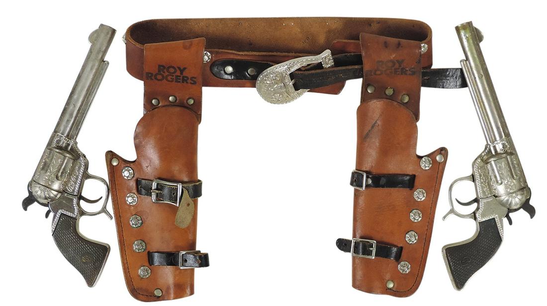 Cap Gun Set, Western Character, Roy Rogers dbl cap gun & holster set, leather belt w/Roy Rogers: Cap Gun Set, Western Character, Roy Rogers dbl cap gun & holster set, leather belt w/Roy Rogers imprints & matching die-cast six shooters, mfgd by Geo. Schmidt, Good+ working cond w/normal wear, 11"H.