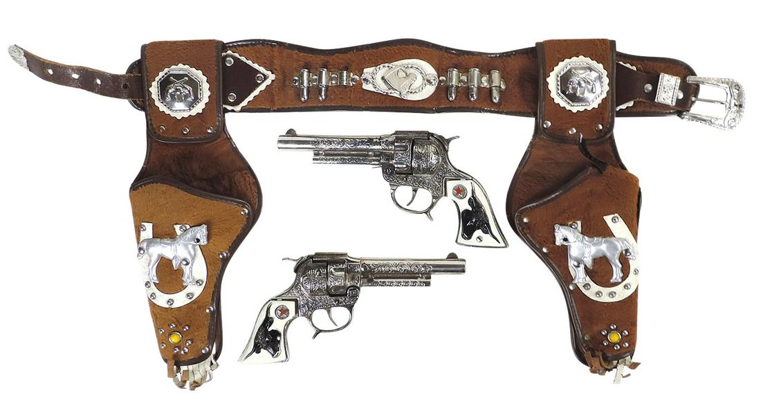 Toy Cap Gun & Holster Set, Texan Jr, mfgd by Hubley, die-cast metal cap guns w/brushed leather: Toy Cap Gun & Holster Set, Texan Jr, mfgd by Hubley, die-cast metal cap guns w/brushed leather holsters mounted w/diecut embossed ponies, VG working cond, 13"H x 29"W.