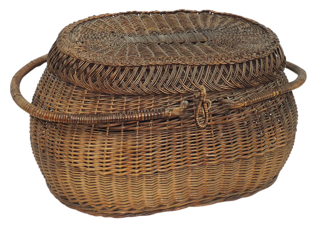 Basketry, woven reed sewing basket w/hinged cover & two handles, VG cond w/few breaks & losses, 12"H: Basketry, woven reed sewing basket w/hinged cover & two handles, VG cond w/few breaks & losses, 12"H x 19"W.