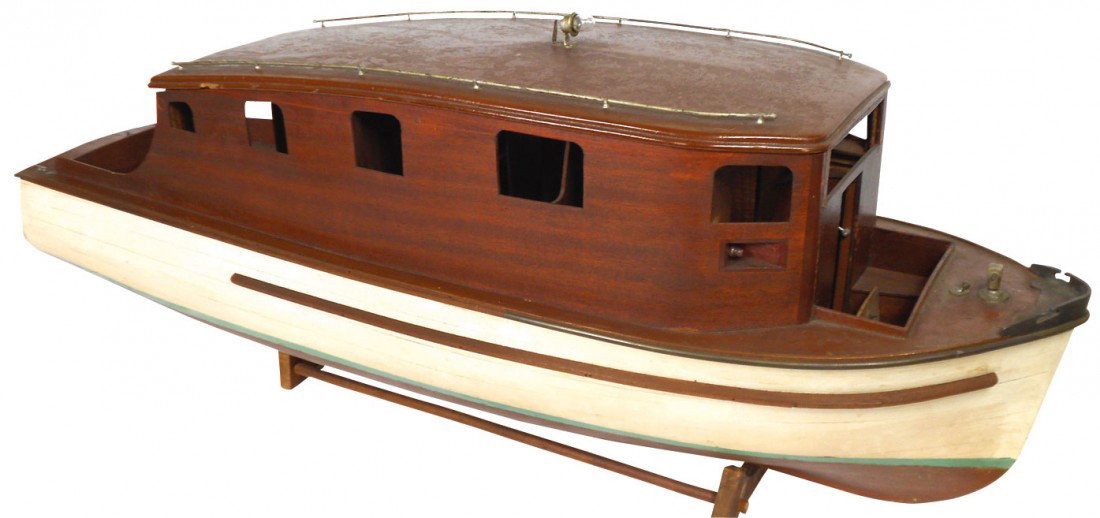 Toy boat, early 1930's wood launch w/unusual driv: Toy boat, early 1930's wood launch w/unusual drive shaft, propeller & battery-powered light, needs some interior work, o/wise VG cond, a very unusual boat, complete w/stand, 43"L.