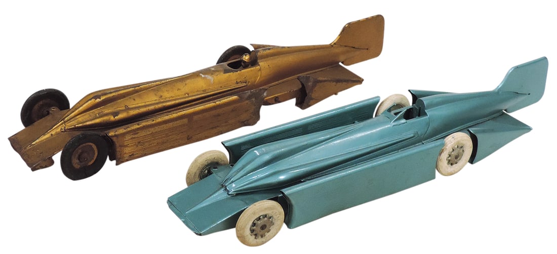 Toy Race Cars (2), mfgd by Kingsbury, tin windup land speeders, c.1930, gold racer in Fair cond: Toy Race Cars (2), mfgd by Kingsbury, tin windup land speeders, c.1930, gold racer in Fair cond w/damaged front wheels, missing a rear wheel & windshield, other in VG cond w/missing driver, each 20"L.
