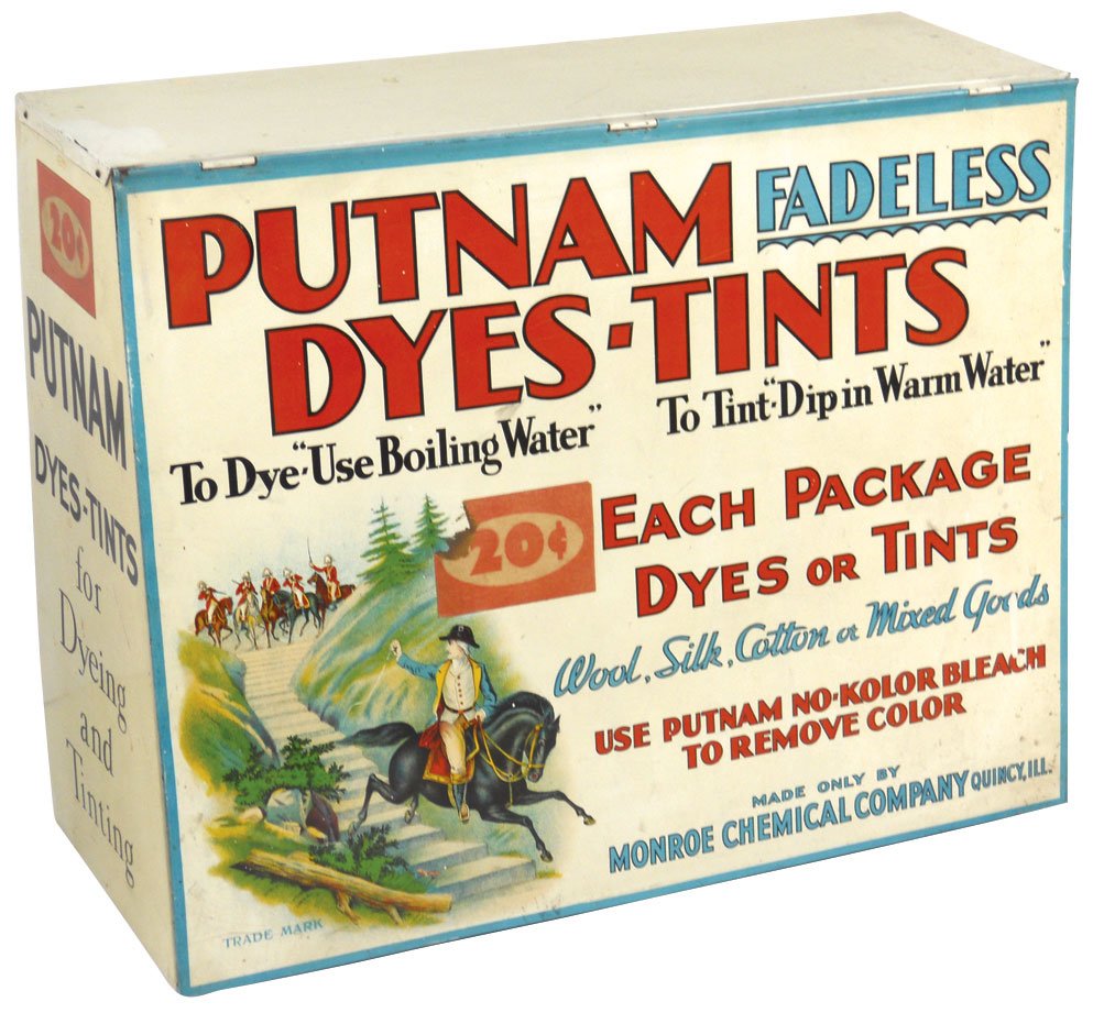 Country store Putnam Dye cabinet, metal w/slanted: Country store Putnam Dye cabinet, metal w/slanted front, by Monroe Chemical Co-Quincy, IL, some old product inside, VG/Exc cond, 15"H x 19"W x 8"D.