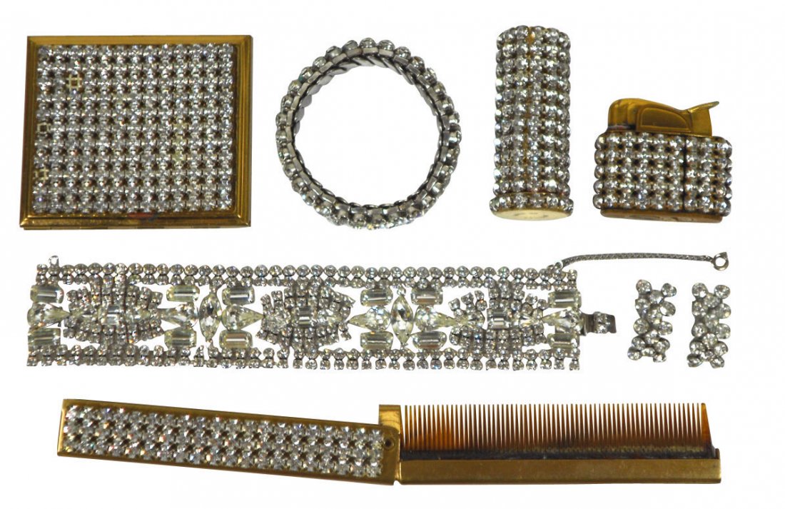 Jewelry, 8 pcs, includes matching gold-plated rou: Jewelry, 8 pcs, includes matching gold-plated round-cut rhinestone lipstick case marked Wiesner of Miami, comb, powder makeup case (mirror inside is broken & some missing stones), lighter, stretch bra