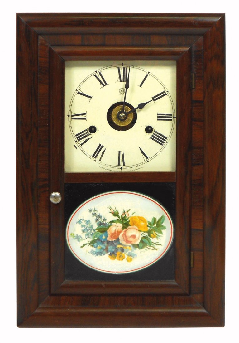 Clock, Seth Thomas, rosewood or mahogany veneer w: Clock, Seth Thomas, rosewood or mahogany veneer w/reverse painted glass, chimes on the hour, c.1820's, VG working cond w/small pc of veneer loss on bottom corner, 16"H x 10.5"W.