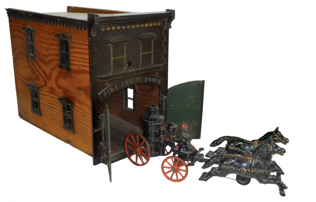 Toy Fire House & Pumper, Ives, cast iron & wood w: Toy Fire House & Pumper, Ives, cast iron & wood w/clockwork mech, when released the bell rings & doors open, cast iron window frames, pumper is black w/gold trim & red wheels, 2 horses have gold reins