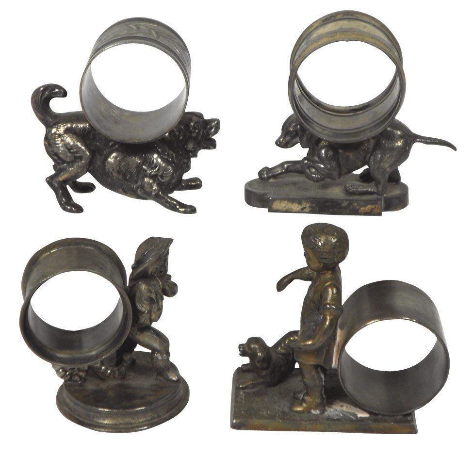 Victorian figural napkin rings (4), c.1870-1900, : Victorian figural napkin rings (4), c.1870-1900, silver-plated girl w/dog, boy w/bag & 2 w/dogs, all VG cond w/orig patina, 2.75" to 3.25"H.