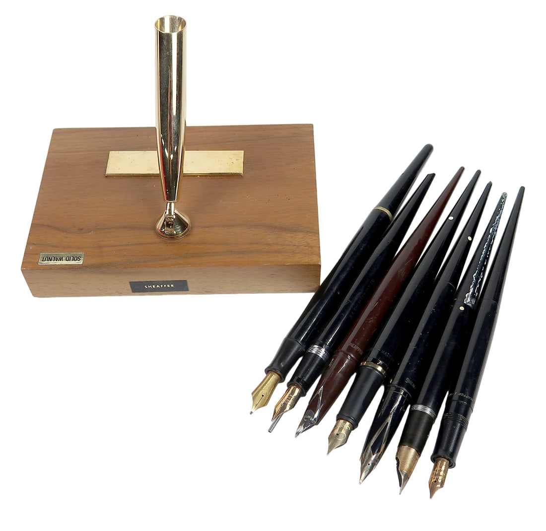 7 Sheaffer Fountain Pens, A Brown Non White Dot Cartridge W/inlaid V Nib In: 7 sheaffer fountain pens, a brown non white dot cartridge w/inlaid v nib in walnut stand, a white dot 14k inlaid v nib, and 5 different 14k vac-fill, g+ to vg+ untested cond, largest 7"l.