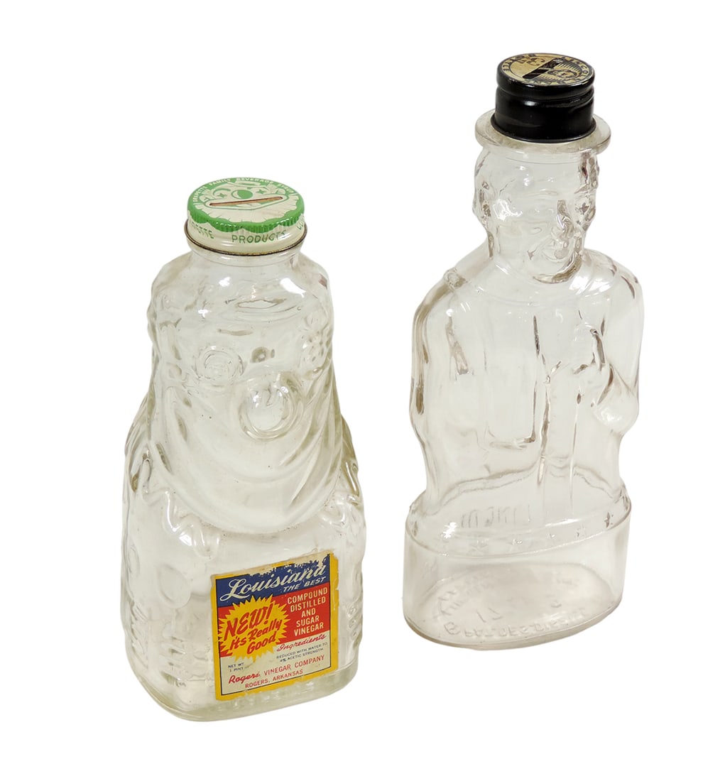 Character Bank Bottles, Abe Lincoln Bank Bottle & Louisiana Vinegar Clown B: Character Bank Bottles, Abe Lincoln Bank Bottle & Louisiana Vinegar Clown Bank Bottle, both with orig advertising lids & clown w/orig paper label, both glass in Exc cond, 8" & 9"H.