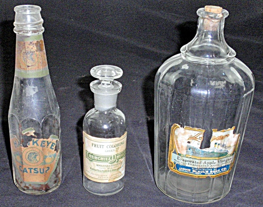 3 Burlington, IA Paper Labeled Grocer Bottles, foe John Blaul's Apple Vineg: 3 Burlington, IA Paper Labeled Grocer Bottles, foe John Blaul's Apple Vinegar, Hawkeye Catsup and Hurchill Drug food coloring, VG Cond with various paper loss, Largest 8"H.