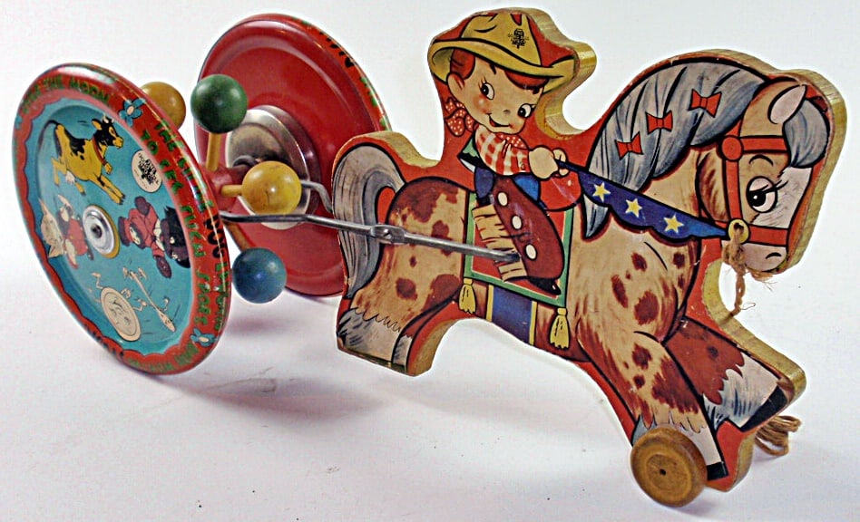 A Cowboy Kid on Horse Pull Toy: Paper litho over wood with yin litho wheels mfg by The Gong Bell Co. Exc working cond 17.5"L.