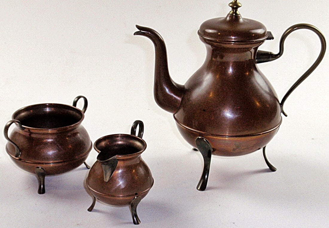 An Oscar Nilsson 3pc Copper Tea Set: With brass handles & feet, Pot signed on base, Exc cond w/natural patina, Largest 8.5”H.
