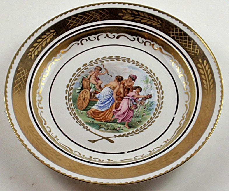 A Royal Copenhagen Charger: With Neo-Classic scene of Cupid & 3 Muses on deep well w/gilt surround, RC mark on verso, Exc cond. 13”Dia.