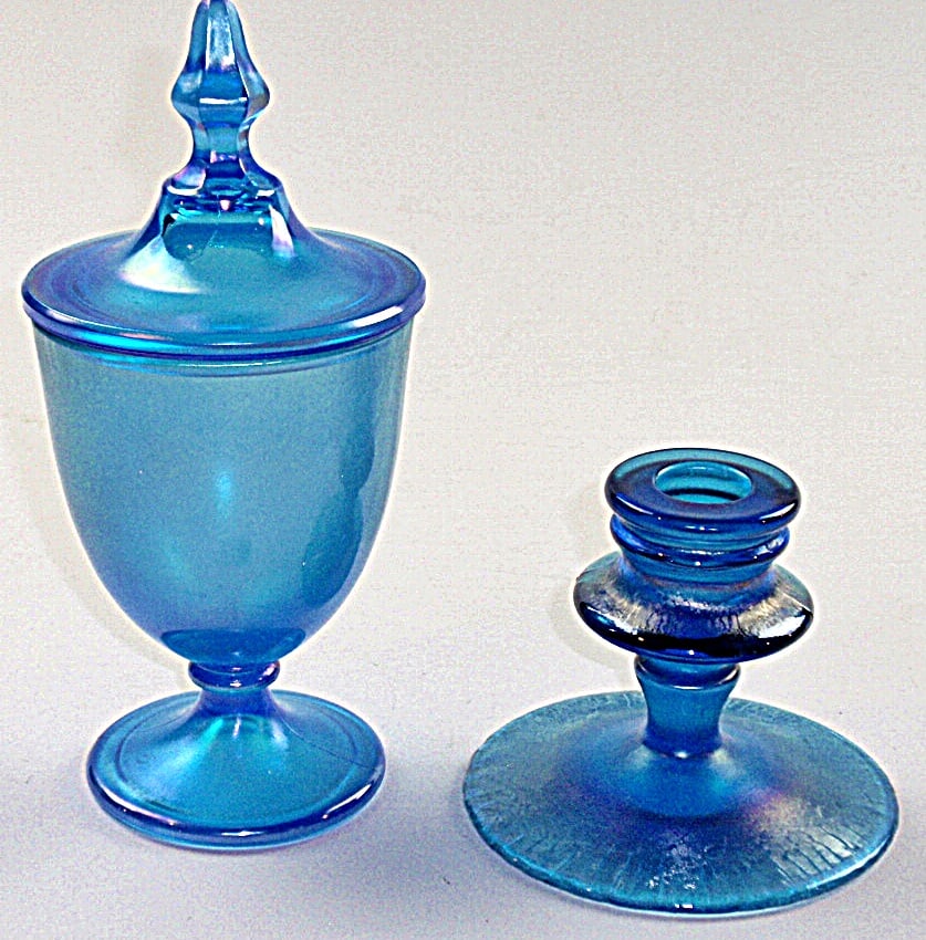 A Pair Of Blue Tiffin Art Glass Pieces: Covered candy urn and candlestick w/iridized stretched finish, Exc cond. Largest 8"H.