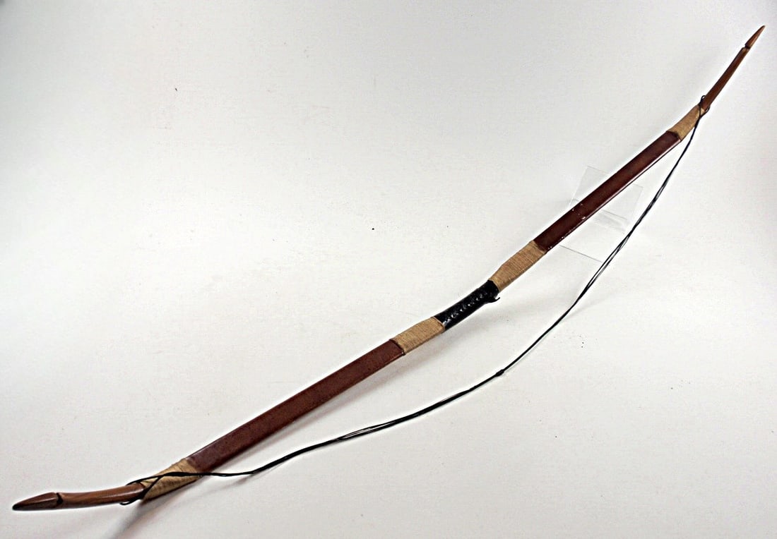 A Carved Wood Recurve Bow: Leather wrapped signed indist and marked 30# VG+ cond. 55"L.