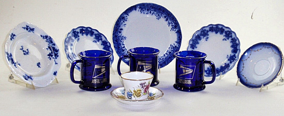 Lot of misc. ceramic and glass dishes (10): Including 3 cobalt blue glass US Postal coffee mugs, a matching Sweet Pea Salisbury fine bone China cup and saucer made in England, and misc. plates. All in good cond. Largest approx. 8" wide.