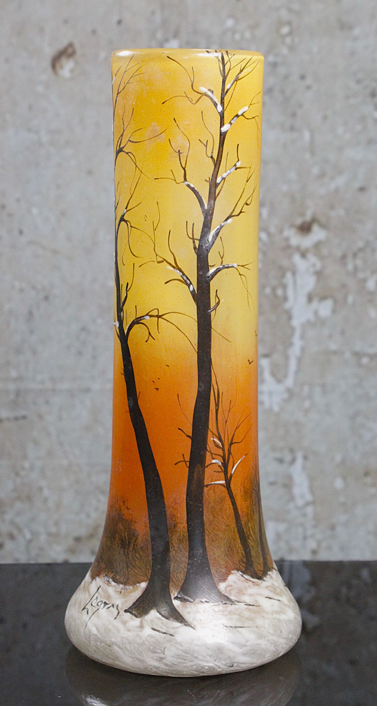 A Legras Winter Scene French Art Glass Vase: Enameled with thick frosty white on an amber ground w/barren trees in charcoal, signed in enamel "Legras" Exc cond, 12"H.